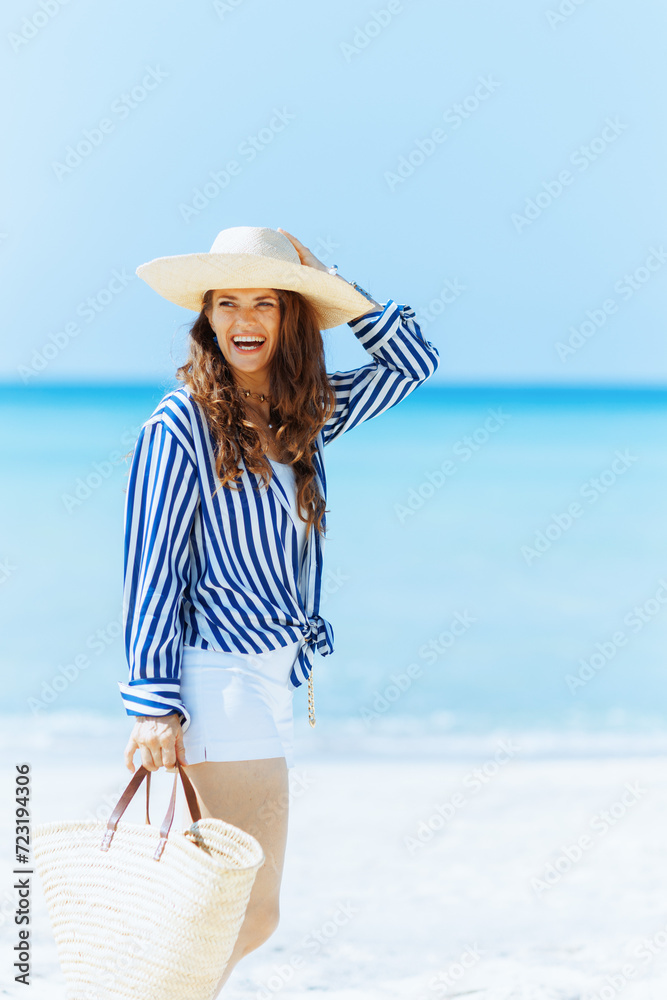 smiling elegant 40 years old woman on seashore