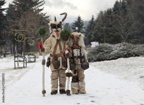 Pernik, Bulgaria - January 27, 2024: The 30th International masquerade festival Surva in Pernik, Bulgaria. People with mask called Kukeri dance and perform to scare the evil spirits. photo