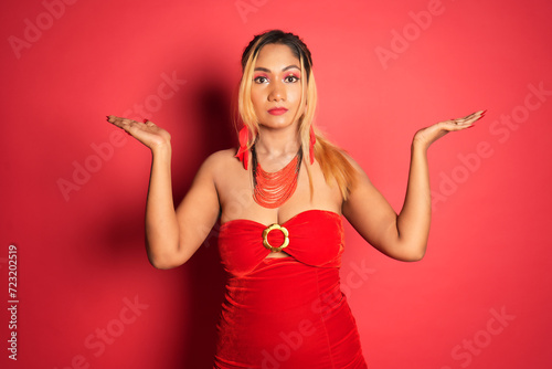 a pretty woman holding her hands up to the sky as she looks at something