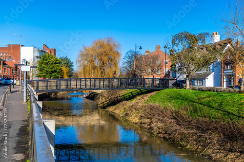 A view towards a footbridge over the River Welland opposite Welland Place in the centre of Spalding, Lincolnshire on a bright sunny day photo