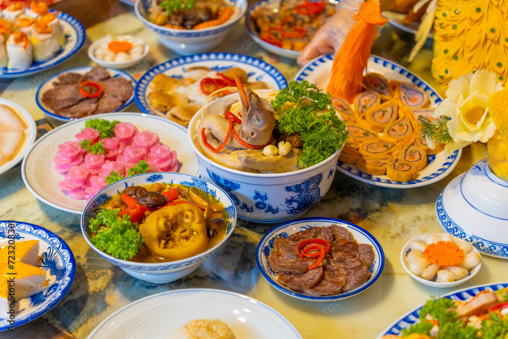 Tet tray. Full of traditional dishes. Chinese new year festival table with asian food. Vietnamese food for Tet holiday in lunar new year. Text on food meaning happy and peaceful.