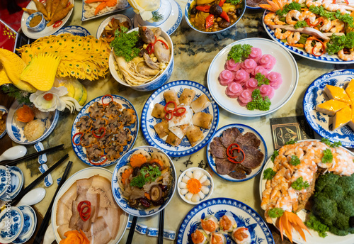 Tet tray. Full of traditional dishes. Chinese new year festival table with asian food. Vietnamese food for Tet holiday in lunar new year. Text on food meaning happy and peaceful. photo