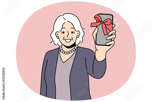 Smiling old woman show smartphone with bow as present. Happy mature grandmother excited with new cellphone gift. Elderly and technology. Vector illustration.