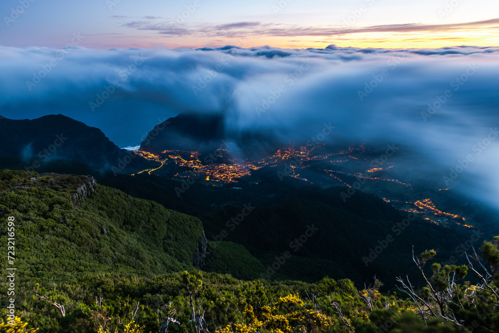Scenic view of town under fog in Madeira Island at sunrise