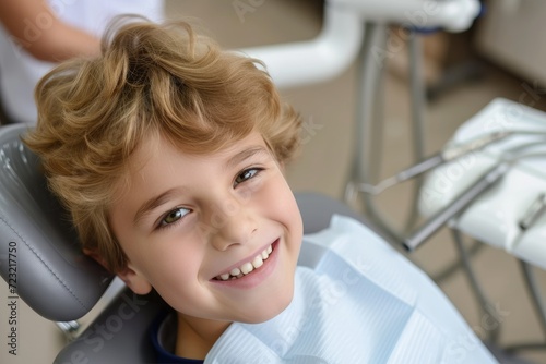 A smiling child sitting in ...