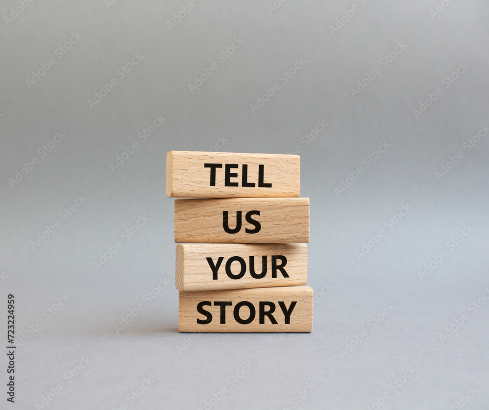 Tell us your story symbol. Concept words Tell us your story on wooden blocks. Beautiful grey background. Business and Tell us your story concept. Copy space. Tell us your story symbol. Concept words Tell us your story on wooden blocks. Beautiful grey background. Business and Tell us your story concept. Copy space.