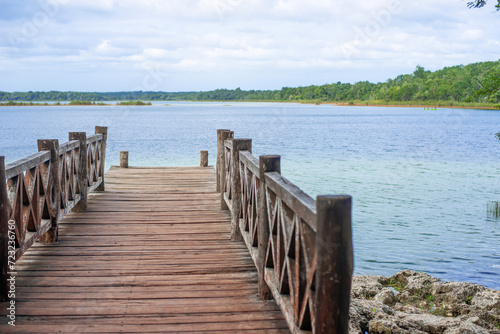 wooden pier on the shore of a fresh water lake in the Central American jungle
