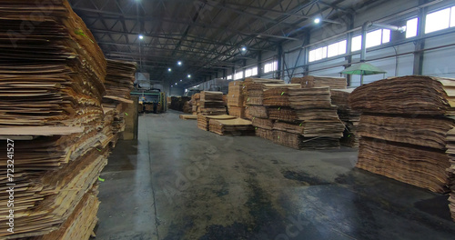 Sheets of plywood slabs are stacked in the warehouse of the woodworking plant