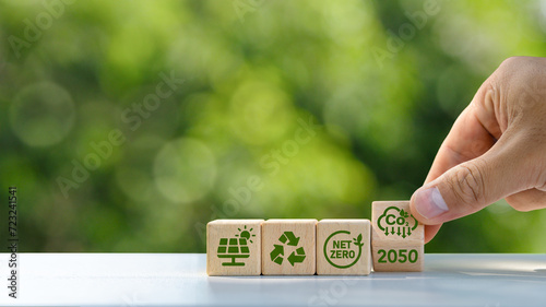 concept of carbon credit reducing carbon emissions Zero net greenhouse gas emissions target Carbon credits to invest in sustainable businesses green climate investment wooden block with green icon
