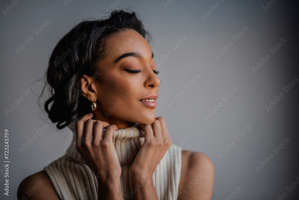 Attractive african american woman against grey background Attractive african american woman against grey background