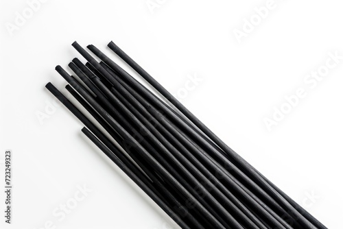 Black incense stick on white background viewed from above