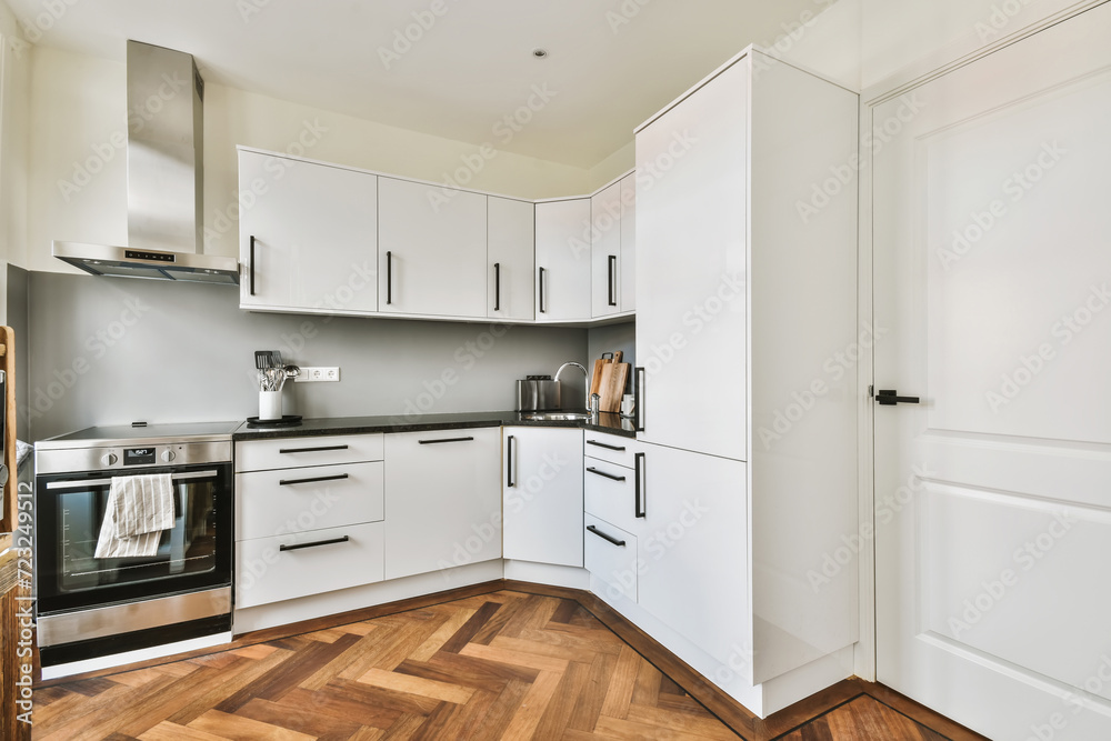 Modern kitchen interior with white cabinets and wood floor Modern kitchen interior with white cabinets and wood floor