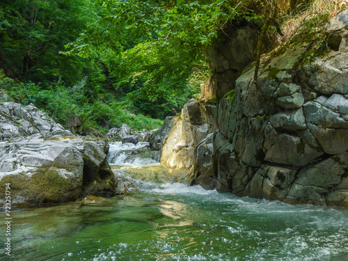 Gilort river forming stepped cascades and ponds when flowing rapidly through eroded limestone walls. The water is fresh and cold. Parang Mountains, Carpathia, Romania. photo