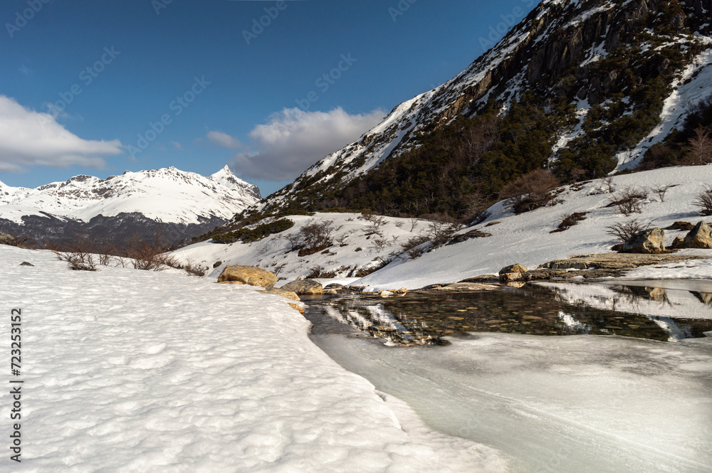 Mountain range melting river, with snowy mountains in the background. Emerald Lagoon, Ushuaia