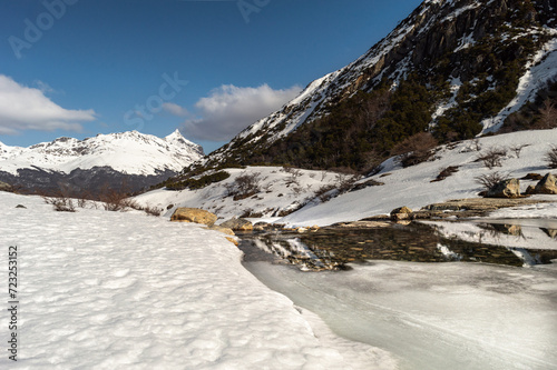 Obraz na płótnie Mountain range melting river, with snowy mountains in the background. Emerald Lagoon, Ushuaia w salonie