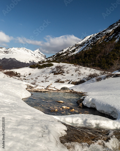 Obraz na płótnie Mountain range melting river, with snowy mountains in the background. Emerald Lagoon, Ushuaia w salonie