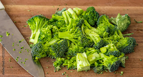 Healthy fresh meal cooking, broccoli on wooden board preparation. Homemade vegetables for restaurant, menu, advert or package, close up, selective focus.