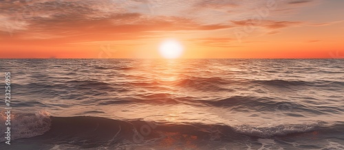 Calm sea with sunset sky and sun through clouds above. Meditation sea and sky background.