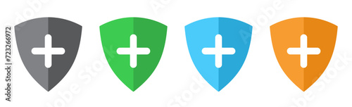 Security shield icon with plus symbol set of four flat design in different colors.