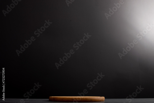 Black background with wooden pizza board