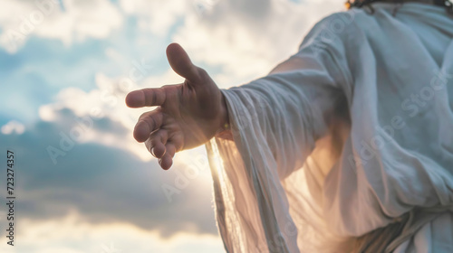 Jesus Christ in white clothes extends his hand to you against the sky as a symbol of Christianity