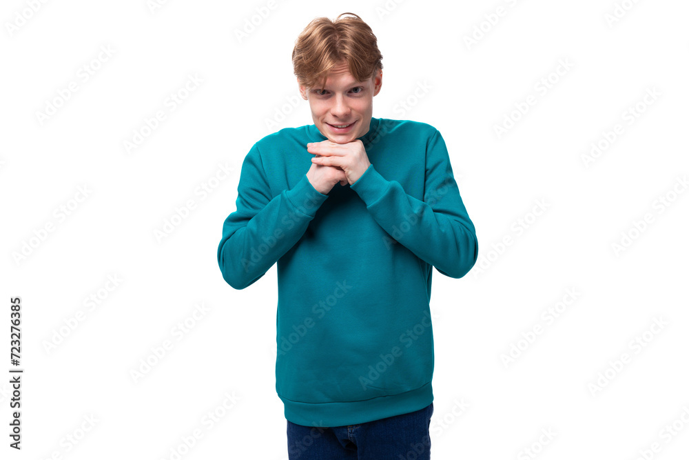 surprised caucasian young red-haired guy dressed in a blue pullover on a white background with copy space surprised caucasian young red-haired guy dressed in a blue pullover on a white background with copy space