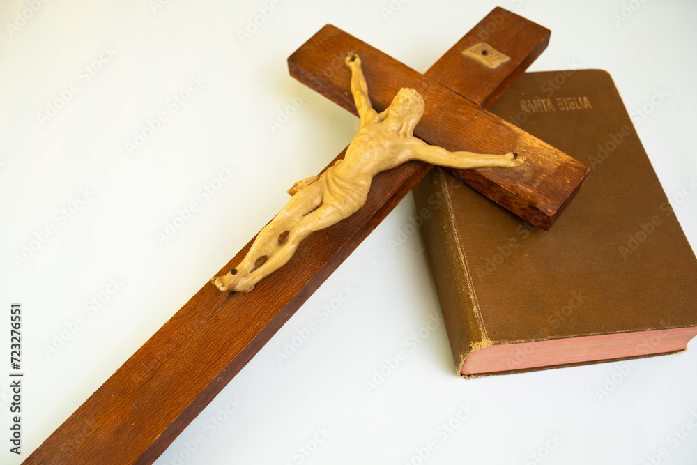 wooden cross resting on the bible, with copy space