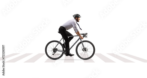 Profile shot of a businessman riding a bicycle at a pedestrian crossing