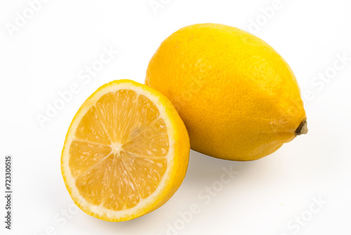 Lemon isolate on white. Lemon fruit whole and a half with leaves. Side view on white. With clipping path.
