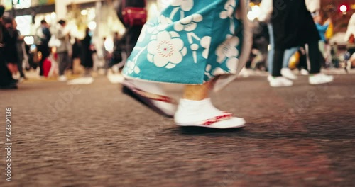 Japan, person and walk in shoes in kimono, city and travel for heritage in streets with people. Feet, slippers or traditional clothes in tokyo culture, elegant or commuting in style dress as fashion photo