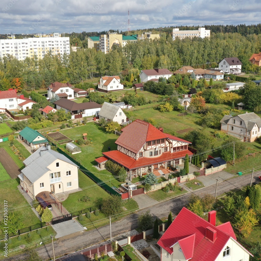 Residential settlements on a mountain, hill, view from the top. Private houses, cottages, in the neighborhood with high-rise urban residential development. How houses are built on steep slopes. Residential settlements on a mountain, hill, view from the top. Private houses, cottages, in the neighborhood with high-rise urban residential development. How houses are built on steep slopes.