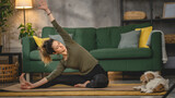 Woman practice yoga on mat in living room at home