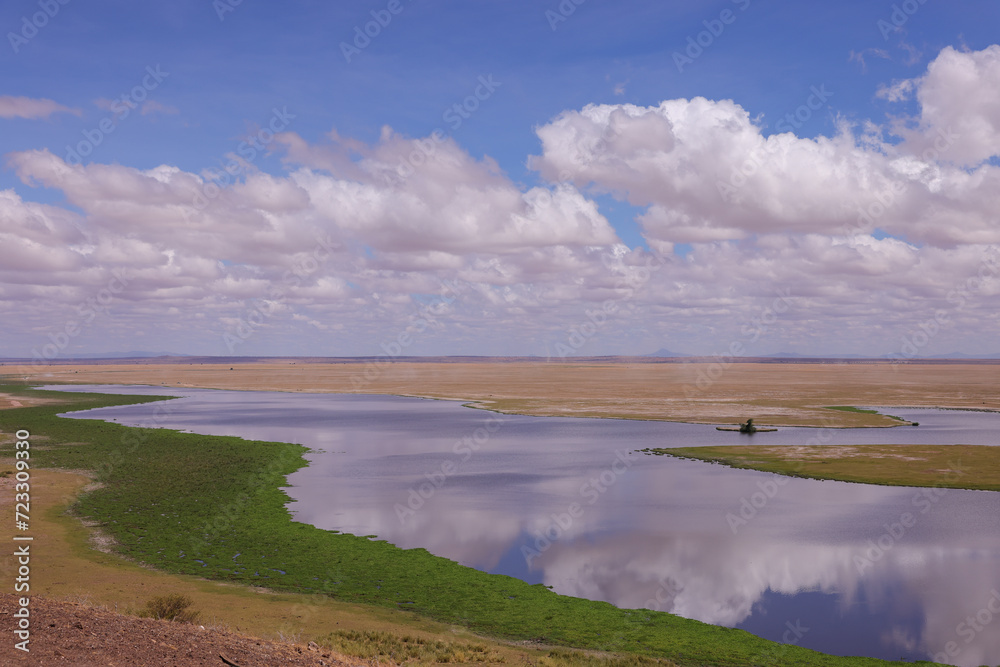 high angle view of lake landscape of Amboseli NP with reflecting clouds on the water surface