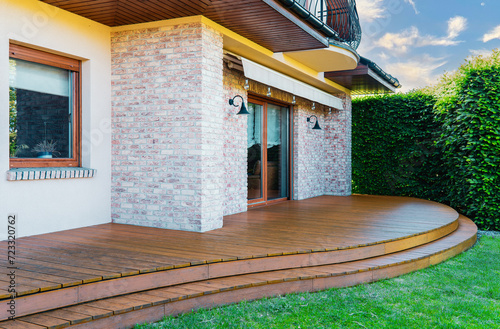 Luxury villa exterior with garden terrace and wooden exotic floor. photo