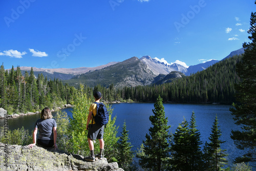 Male hiker with backpack looking over Bear Lake in Colorado Rocky Mountain National Park