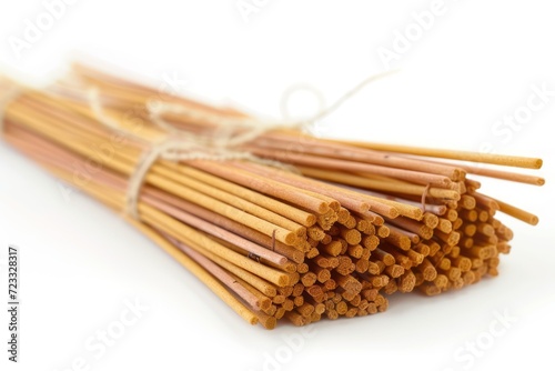Multiple scented incense sticks joined by twine on a white surface