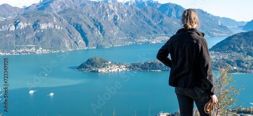 A hiker enjoying the magnificent view of Bellagio at lake Como seen from Monte Crocione photo