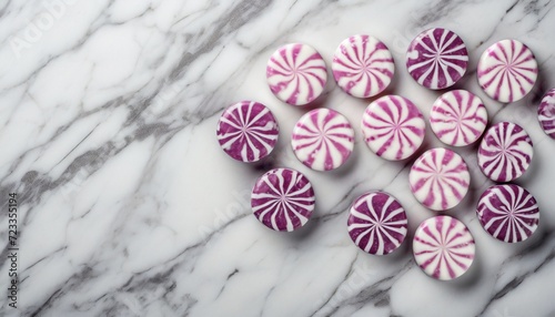 round peppermint candies on white marble surface
