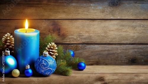 christmas burning blue candle and christmas decorations on wooden background christmas day horizontal greeting and invatation banner with copy space for advertisement and other usage photo