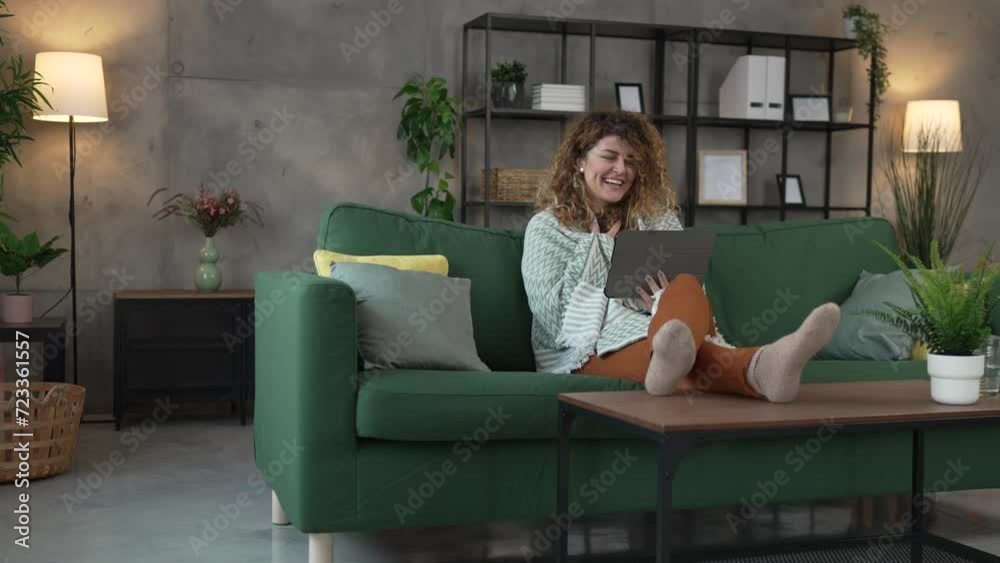 Woman sit at home use digital tablet to watch movie or have video call