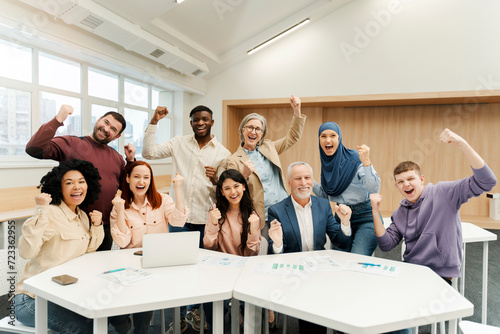 Wallpaper Mural Group of overjoyed multiracial business people using laptop celebration success, win money, working together in modern office. Portrait happy startup team meeting. Successful business concept  Torontodigital.ca