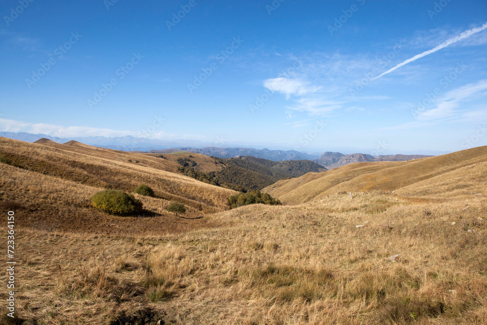 A picturesque view of the Biychesyn plateau and the Caucasus ridge from the Marinsky pass or Gumbashi pass (Gum-Bashi, Kum-Bashi) height 2187 meters. Karachay-Cherkessia. Russia