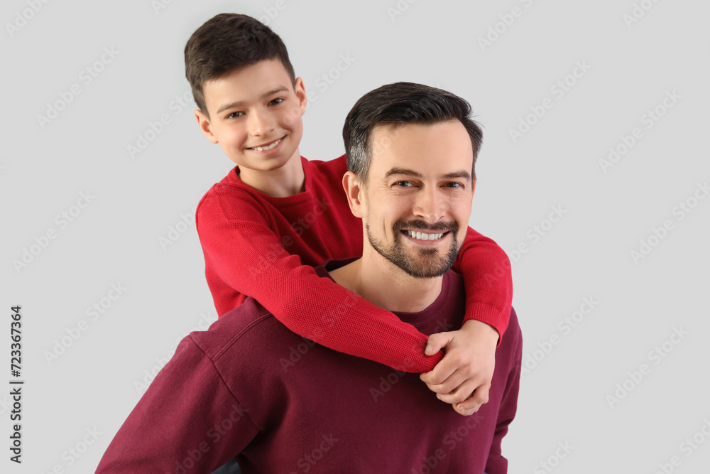 Portrait of father and his little son on light background Portrait of father and his little son on light background