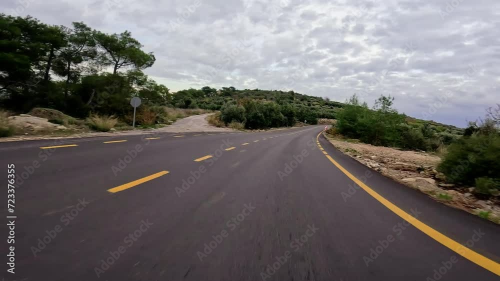 Car driving on rural mountain road, immersed in nature. Road trip in nature, rural scenery with yellow markings. Nature-focused road travel in rural mountains, sunny Car driving on rural mountain road, immersed in nature. Road trip in nature, rural scenery with yellow markings. Nature-focused road travel in rural mountains, sunny