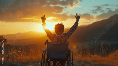 disabled boy in a wheelchair watching a happy sunset in a meadow in high resolution and quality photo