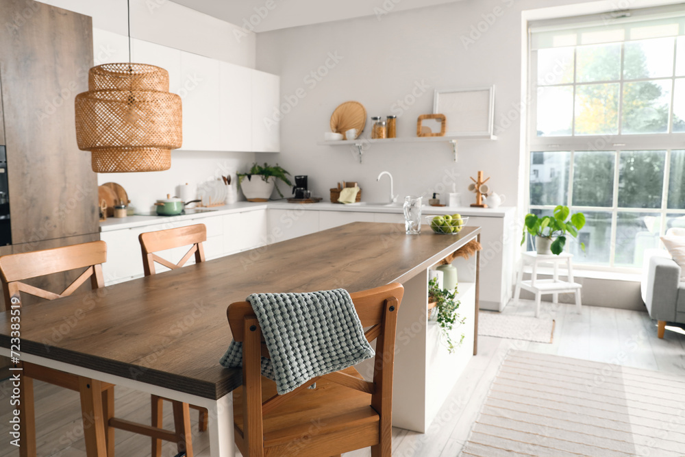 Clean island table with wooden chairs in interior of modern kitchen Clean island table with wooden chairs in interior of modern kitchen