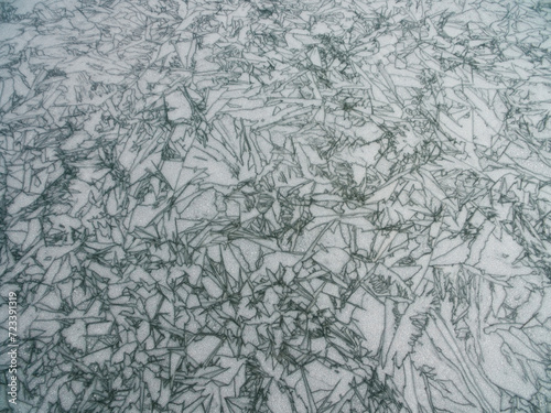 Ice mosaic on the frozen Święcajty Lake, Mazury, Poland