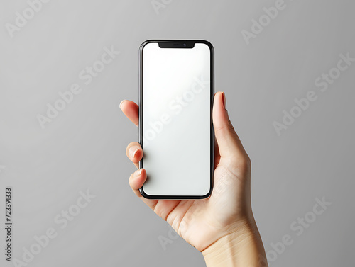 Close-up of a smartphone mockup held in one hand against a grey wall background. Created with Generative AI. photo