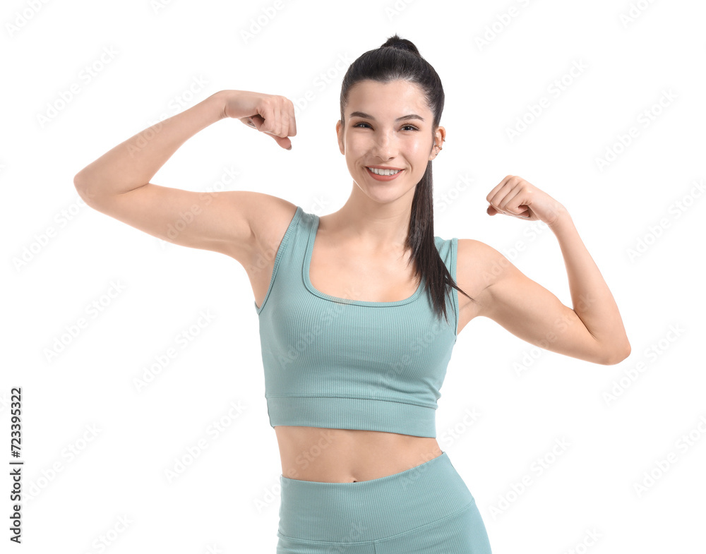 Pretty young woman in sportswear flexing on white background Pretty young woman in sportswear flexing on white background