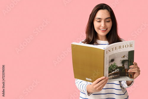 Smiling young woman reading...